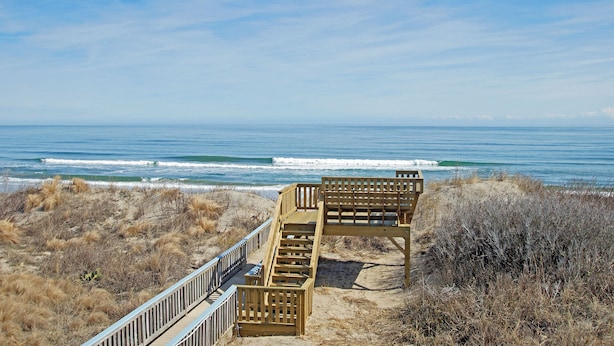A wooden boardwalk leading to a beach with ocean views. - WH1091- Oceanfront-  6 BRs, Cargo Lift, Great Ocean Views Dog Friendly! (Corolla)