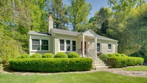 A two-story house with a front porch, a chimney, and a well-maintained lawn. - 7 Mi to the Biltmore: 'Le Canard' Cottage w/ Porch (Arden)