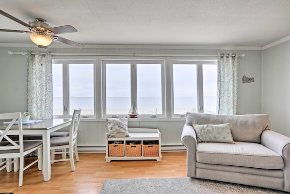 Enjoy a spacious room with a high ceiling, ceiling fan, and large window offering a view of the sky.