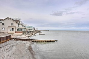 Houses line the coast, offering ocean views from residences.