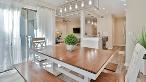 A dining area with a wooden table, chairs, a potted plant, and a ceiling light fixture. - 2311 Racquet Club: 3BR 2 BA Villa. Community Pool and Clay Tennis, Free Bikes (Hilton Head Island)