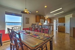 Enjoy cooking in this well-equipped kitchen with a large island, wooden cabinets, and a microwave.