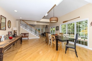 Enjoy a spacious room with a dining area and a view of the outdoors, featuring a mix of modern and traditional decor.