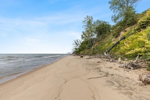 Escape to a serene beachside haven with a sandy shore and lush natural surroundings.