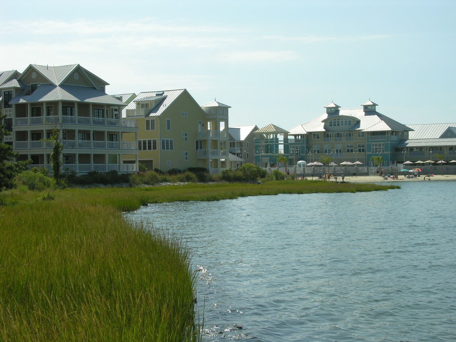 A waterfront property with multiple buildings, including a large multi-story structure with balconies.