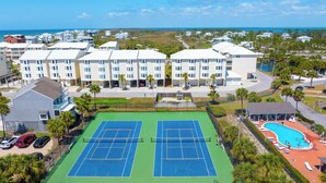 A multi-story hotel with a tennis court and pool area. - Gated Community, Pool, Green Space, Great Beach Access - SeaCliff (Cape San Blas)