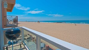 A balcony with a view of a sandy beach and the ocean. - Cheery and bright upstairs unit is a perfect beach getaway! (Newport Beach)