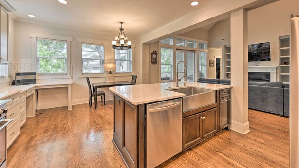 A spacious kitchen with a central island, built-in appliances, and a dining area. - 2 Mi to Dtwn: Home in NoDa District Near UNC! (Charlotte)