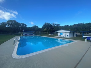 A swimming pool with a lifeguard station and changing rooms. - The Coop at Canyon Lake I Pool & Ideal for Families (Wimberley)