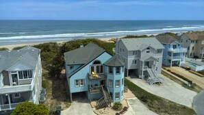 A coastal residential area with houses featuring balconies and a view of the ocean. - Terning Point - Corolla, Crown Point, Oceanfront, 20 Yds to Beach, Pool, Hot Tub, Pets OK (Corolla)