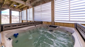 A hot tub with a wooden deck and large windows. - Summer Camp - Corolla, Crown Point, Oceanfront, 70 Ft to Beach, Community Pool, Hot Tub, Pets OK (Corolla)