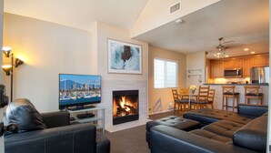 A living room with a fireplace, a television, and a sofa.