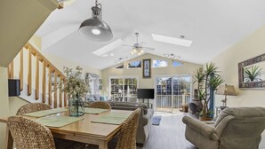 A spacious living area with a dining table, wicker chairs, a sofa, and a ceiling fan. - *Fall into Savings-20% Off New Bookings thru 2026* (Myrtle Beach)