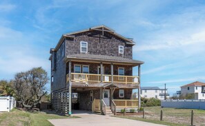 A two-story building with a balcony, a front porch, and a sign indicating 'Carolina Cottage.'