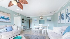 Un salon comprenant un canapé, une table basse et un coin repas avec des chaises et une table.