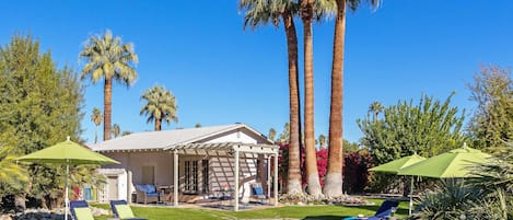 A heated pool, sun loungers