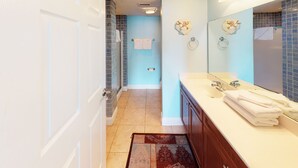 A bathroom with a white sink, a mirror, and a towel rack.