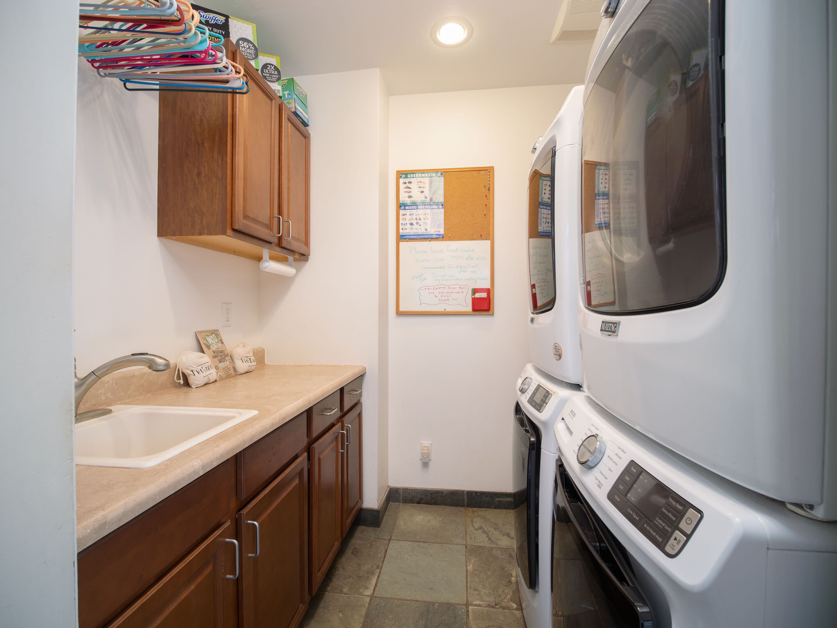 A compact kitchen with wooden cabinets, a sink, and a white refrigerator.