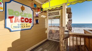 A restaurant named 'Rockin' Tacos' with a sign indicating it is a grill and tequila bar.