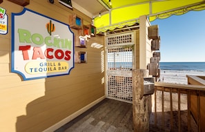 A restaurant named 'Rockin' Tacos' with a sign indicating it is a grill and tequila bar.