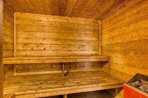A sauna with wooden walls and benches.