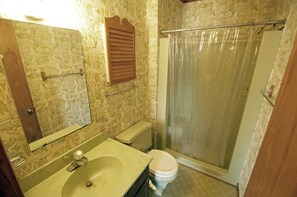 A bathroom with a sink, toilet, and shower.