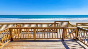A wooden boardwalk leading to a beach with clear blue water. - 910-B Turtle Cove: Beachfront Fun & Pool Access! (Surf City)