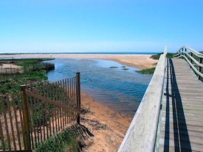 A wooden boardwalk leading to a beach with a clear view of the ocean. - Upscale Elegance, Steps from Ridgevale Beach! (Chatham)