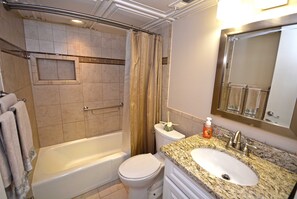 A bathroom with a bathtub, toilet, and sink. - Adorable, spacious 2-bedroom oceanfront condo with free WiFi and a fabulous ocean view located directly on the Boardwalk! (Ocean City)