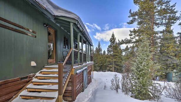 A wooden cabin with a porch and steps leading to a door, surrounded by snow and trees. - 3 Mi to Ski Slopes! Hot Tub Haven in Breckenridge (Breckenridge)