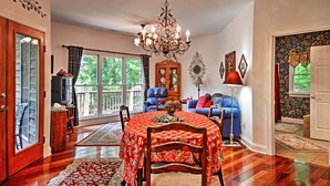 A dining area with a round table, chairs, and a chandelier. - Cozy Scottsville Cottage w/ River Views & Gazebo! (Scottsville)