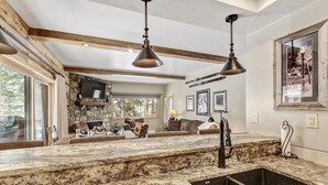A kitchen with granite countertops, a built-in sink, and pendant lighting. - Remodeled! Near Downtown Breckenridge! (Breckenridge)