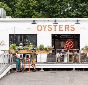 A building with a sign reading "OYSTERS" and a neon sign inside. - PORTLAND PENINSULA-SPACIOUS WALKABLE EAST END SPOT (Portland)