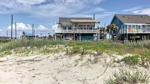 A beachfront property with a main building and a smaller structure. - Furnished Deck, Beachfront Fun! Galveston Getaway (Galveston)