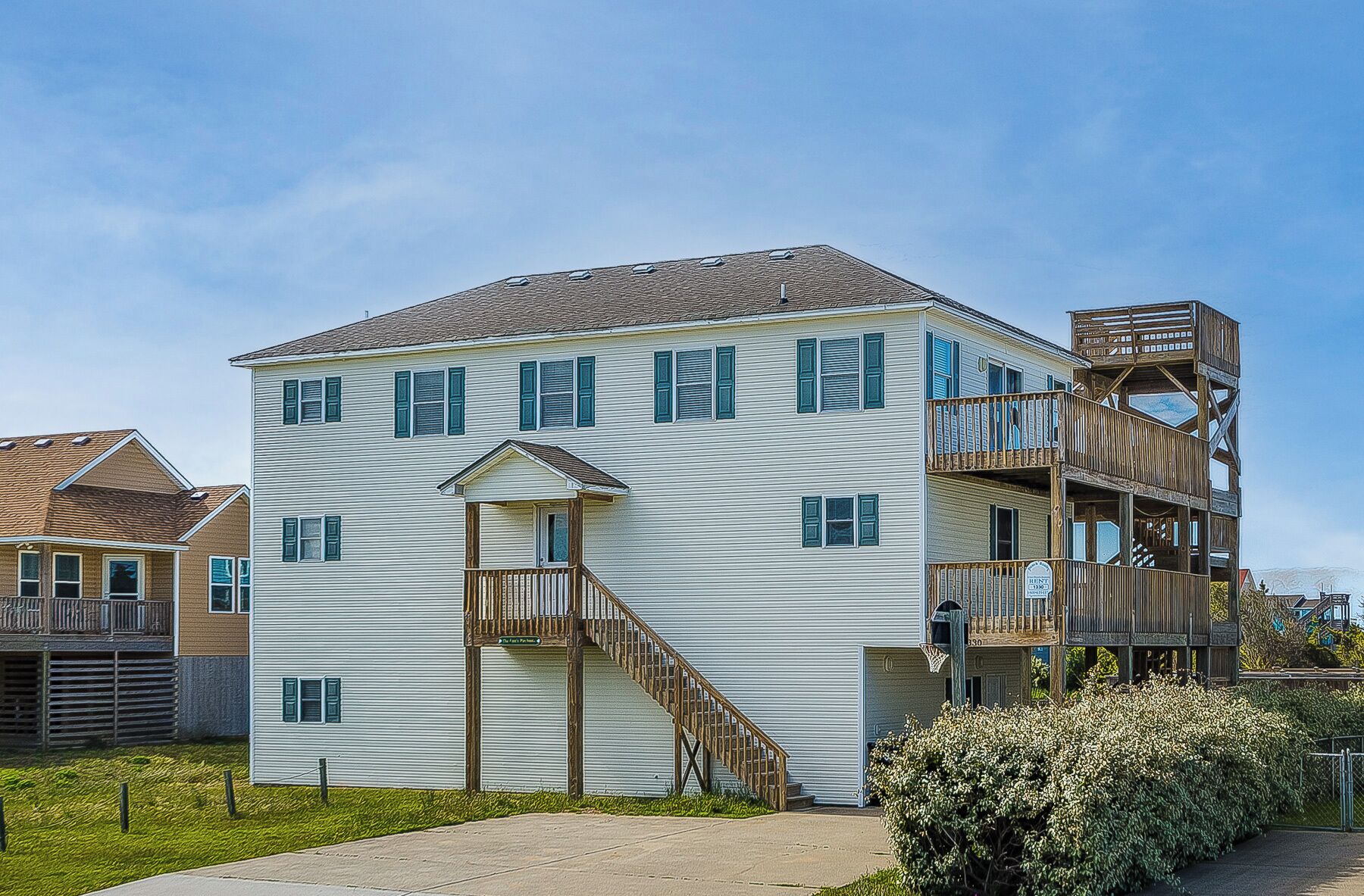 A two-story building with a balcony and a staircase leading to the second floor.