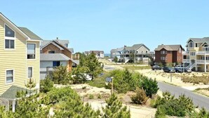 A residential area with houses, a road, and a beach. - OH1213- Just 300 Feet to Beach, 4 BRs, Ocean/Lighthouse Views, Dog Friendly! (Corolla)