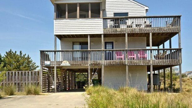 A two-story beachfront house with a balcony on the upper level and a covered entryway. - OH1213- Just 300 Feet to Beach, 4 BRs, Ocean/Lighthouse Views, Dog Friendly! (Corolla)