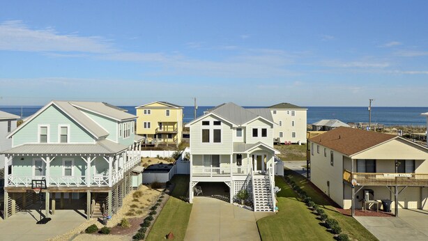 A beachfront residential area with houses featuring balconies and a clear view of the ocean. - KH4004- Oceanside-5 BRs, Elevator, Pool Table, Private Pool and Hot Tub! (Kitty Hawk)