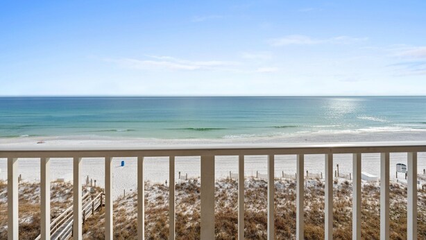 A beach view with a wooden fence and sandy dunes. - SL 502: Palm Bay Villa - Tropical Dreams with Gulf Coast Views! (Fort Walton Beach)
