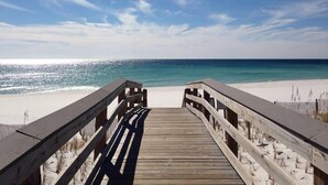 A wooden boardwalk leading to a beach with clear skies and calm waters. - SL 502: Palm Bay Villa - Tropical Dreams with Gulf Coast Views! (Fort Walton Beach)