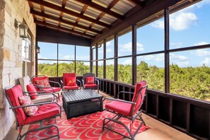 A covered outdoor seating area with a view of the landscape.