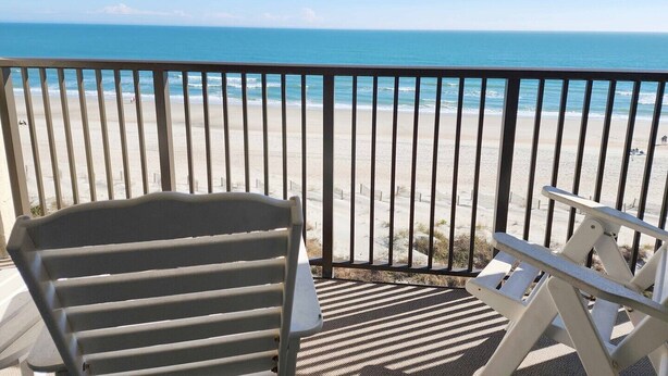 A balcony with a view of a beach. - Direct Ocean & Beach View -Litchfield, Rare 2 Oceanfront Porches! (Pawleys Island)