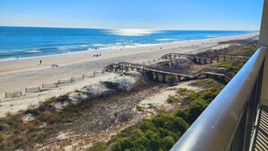 A beach with a wooden pier and a staircase leading down to the shore. - Direct Ocean & Beach View -Litchfield, Rare 2 Oceanfront Porches! (Pawleys Island)
