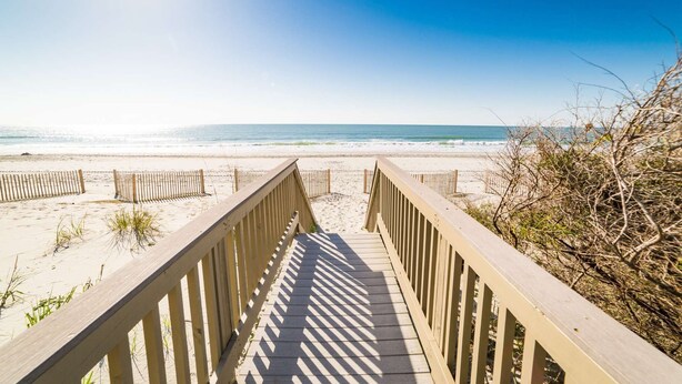 A wooden boardwalk leading to a beach with a clear view of the ocean. - *20% Off New Summer 2026 Bookings* (Surfside Beach)