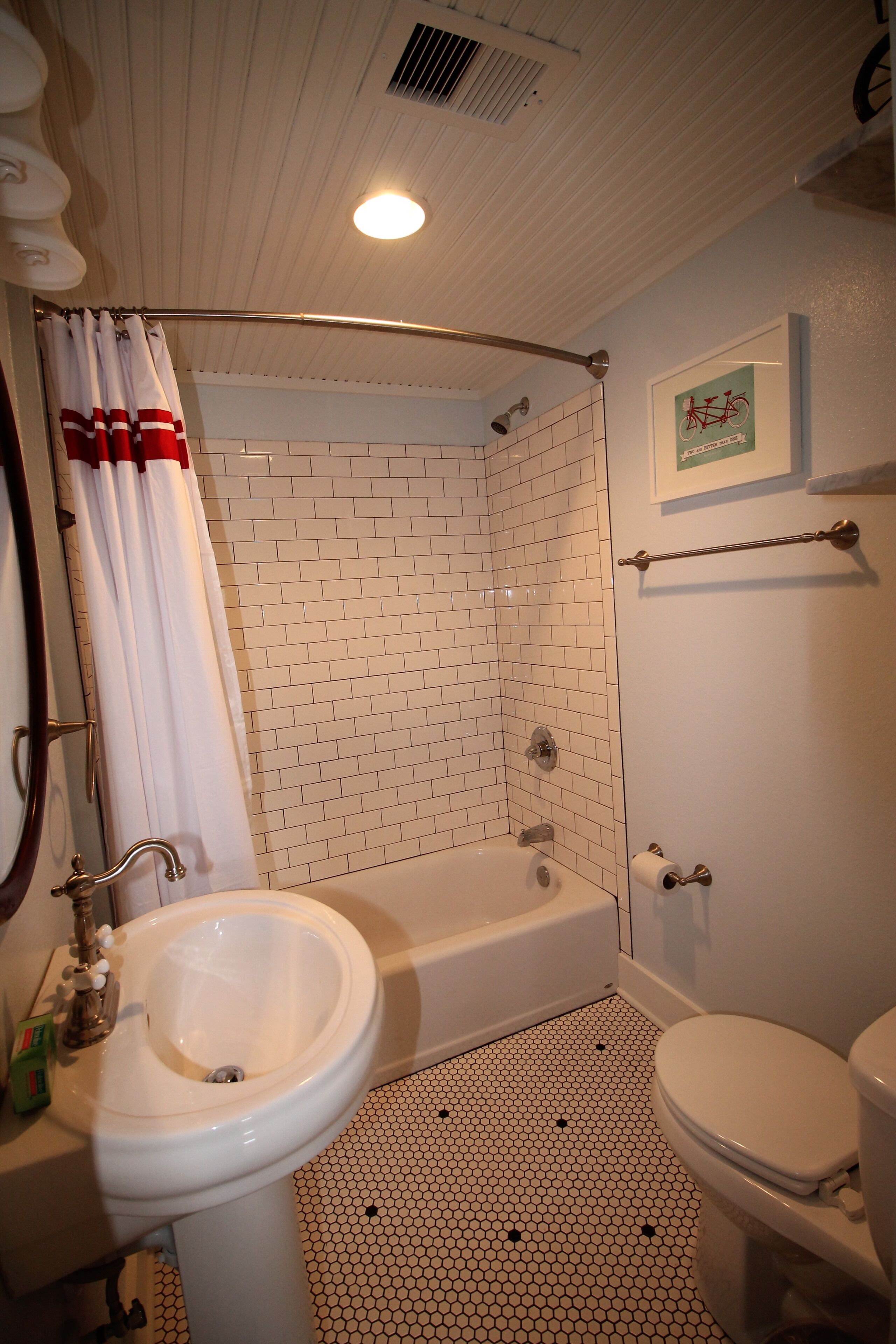 A bathroom with a white sink, toilet, and bathtub.