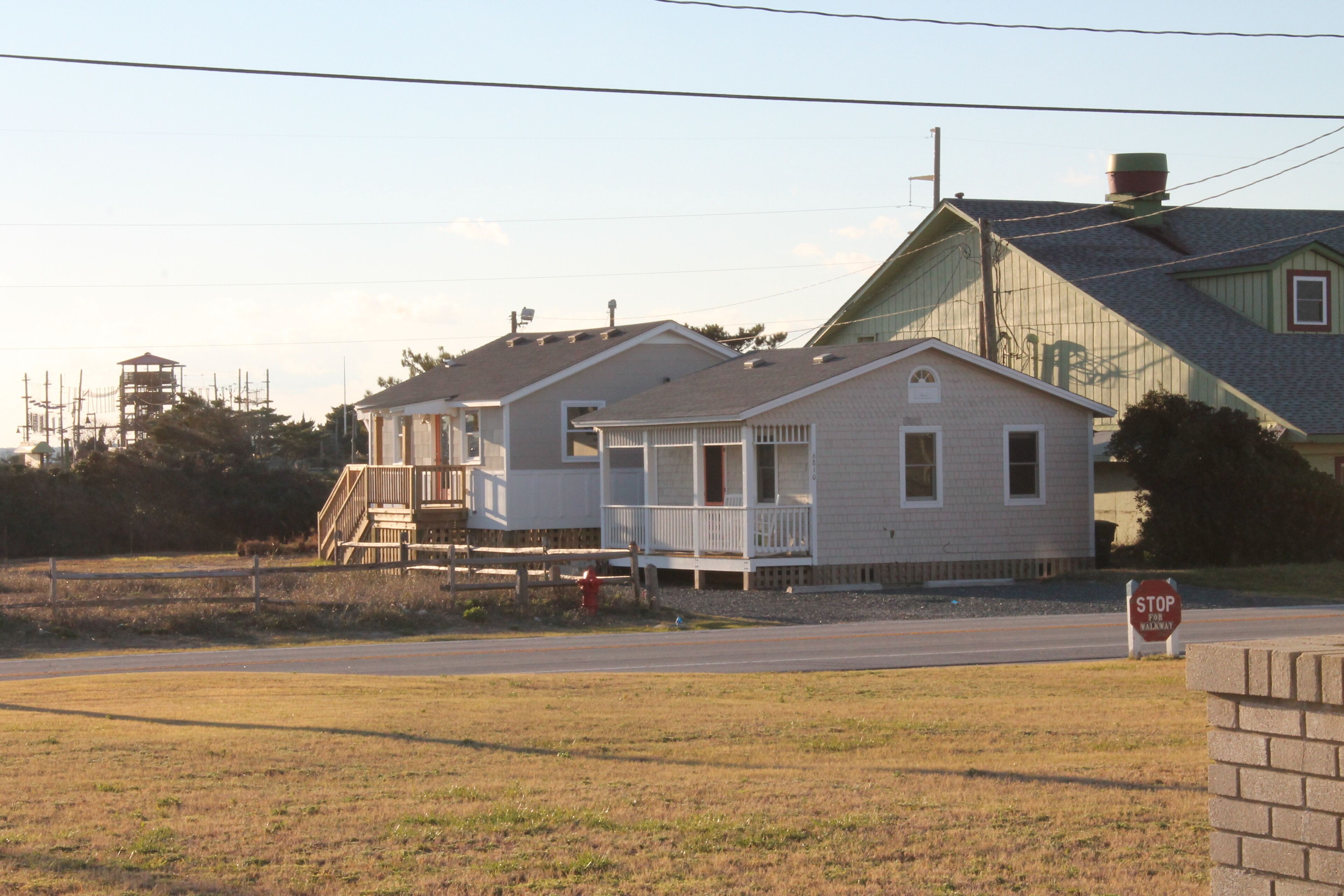 A residential area with houses, a stop sign, and a fire hydrant.
