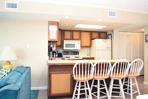 Fridge, microwave, oven, stovetop - Warm, spacious 2-bedroom oceanfront condo with a beach and ocean color gradient, free WiFi, and a mind-blowing ocean view located midtown and just steps to the beach! (Ocean City)