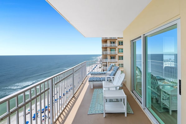 Relax on the balcony with ocean views, a lounge chair, and a small table.