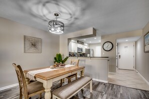 Enjoy meals in this cozy dining area with a wooden table, comfortable chairs, and a bench.