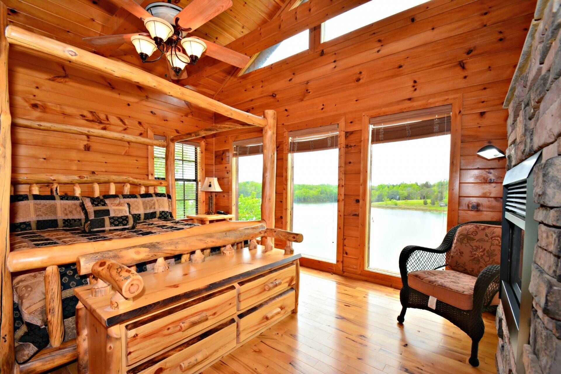 2nd floor King Size Bedroom with electric fireplace and TV with lakeside views and access to balcony.